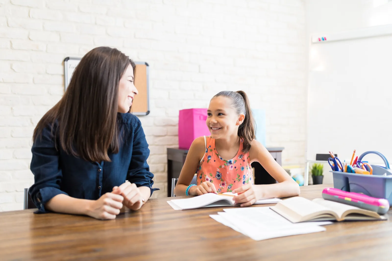 A tutor helping a learner work through homework at home