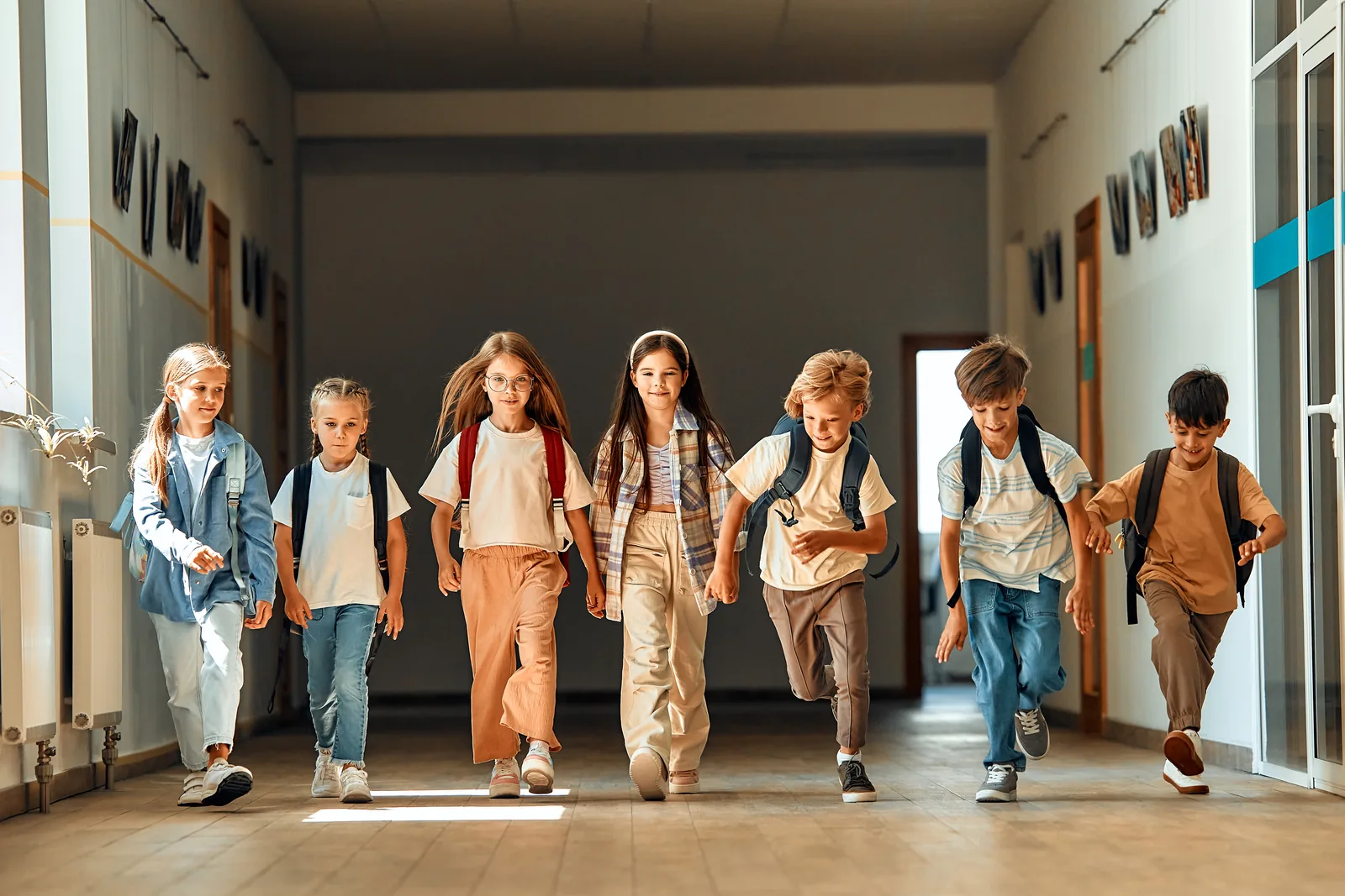 Students walking together through a bright school hallway