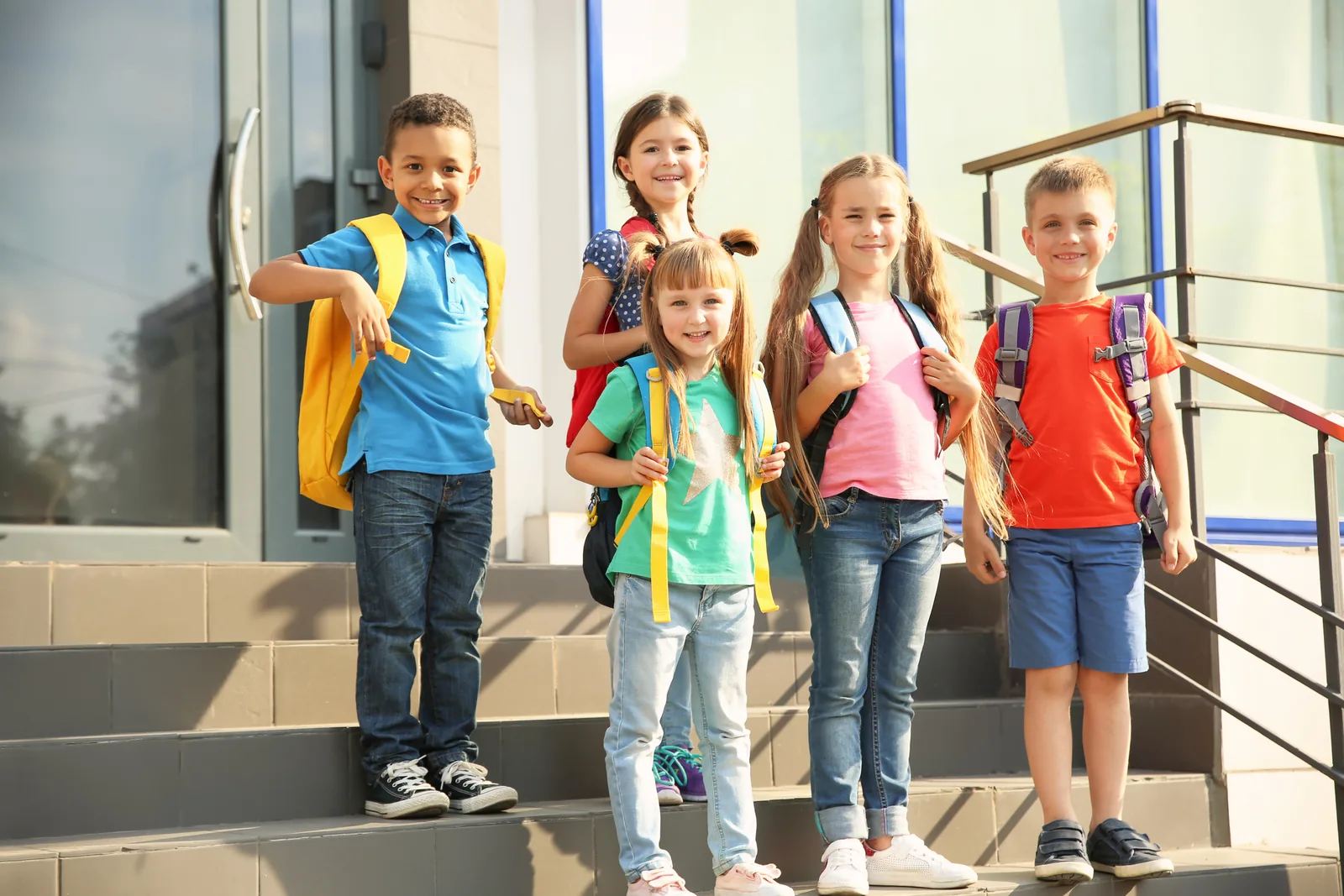 Children carrying backpacks during an outdoor family day trip