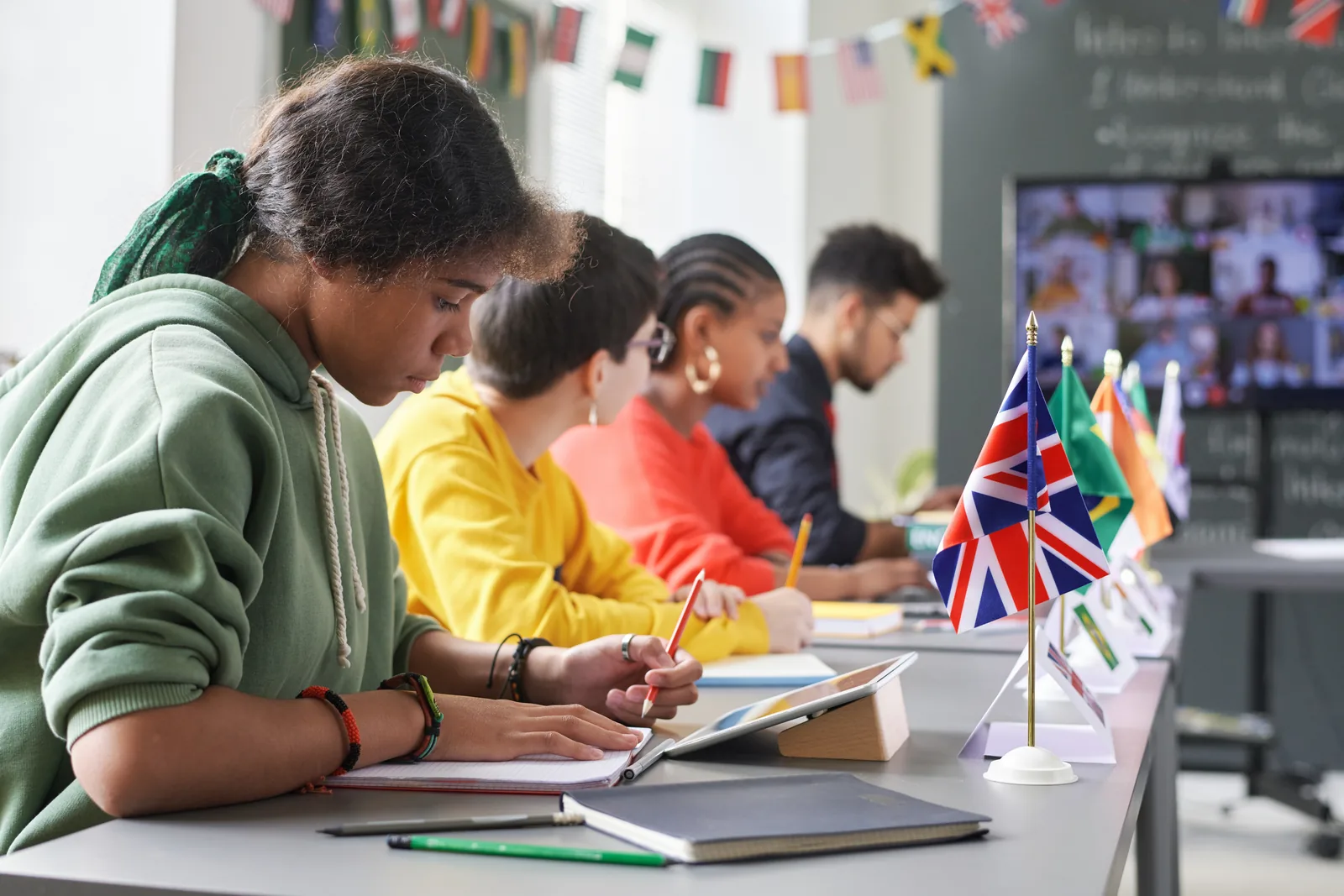 Teen students working in a row during class