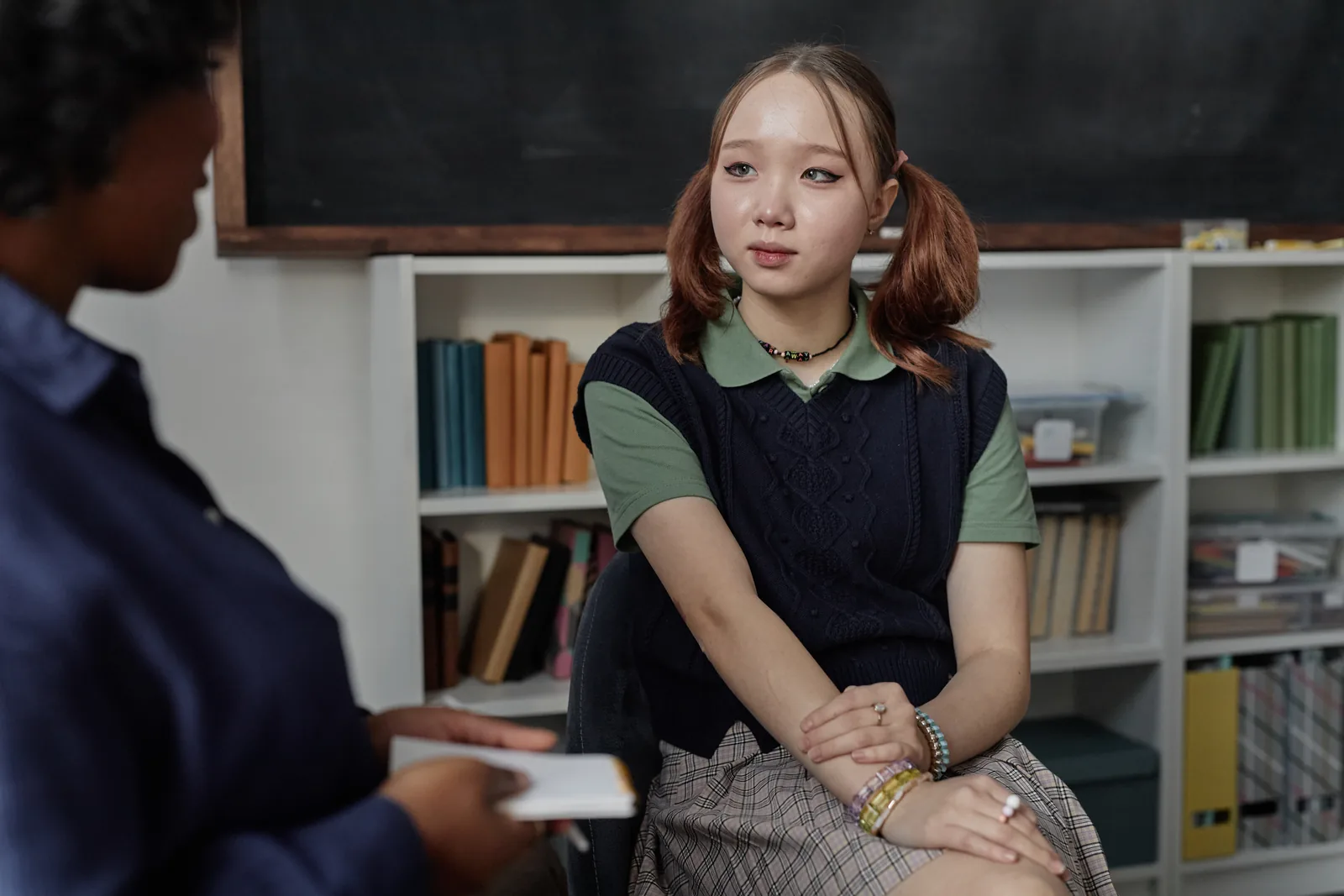 High school student having a focused planning conversation with an adult