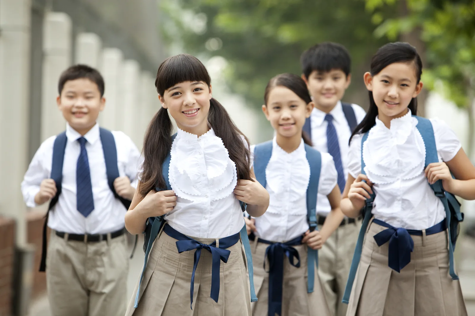 Middle school students walking to school with backpacks