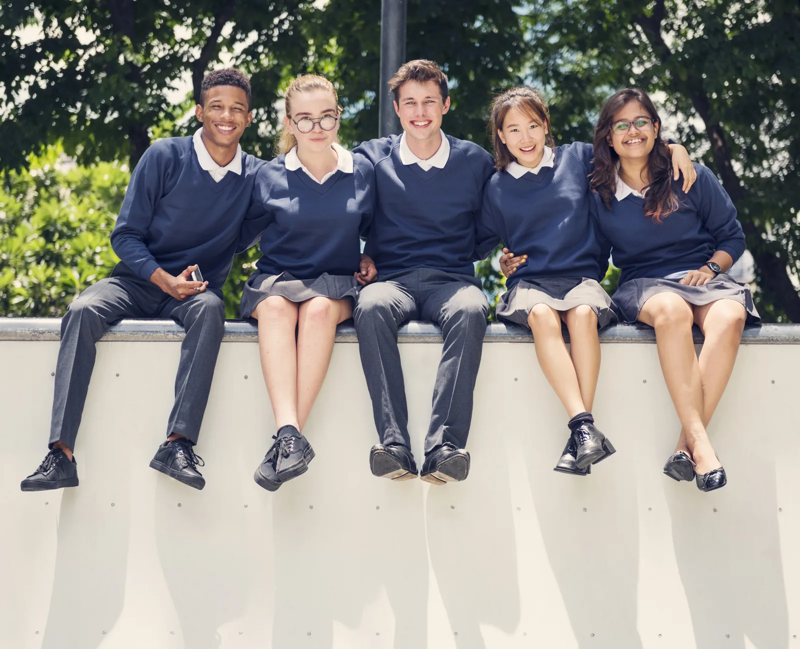 Five private high school students sitting together outside