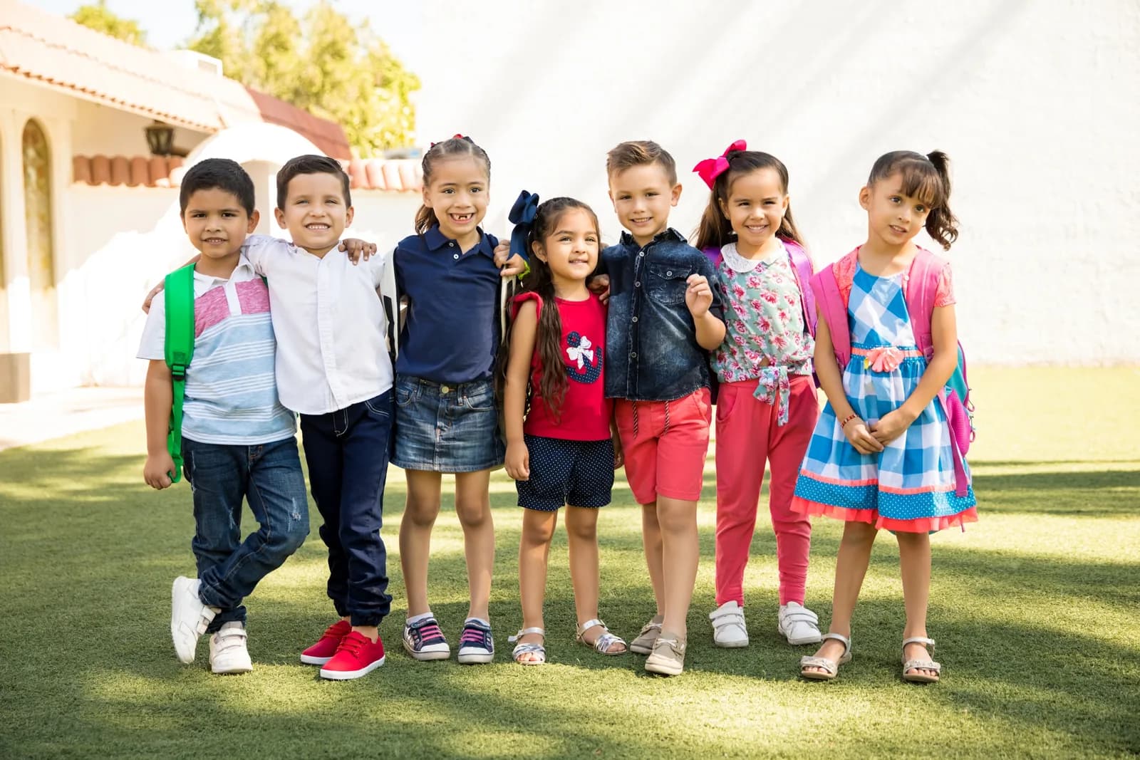 Elementary school students standing together outside school