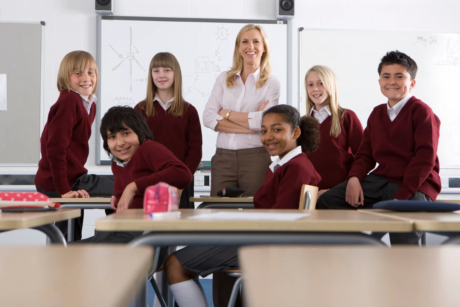 Middle school students and a teacher together in a classroom